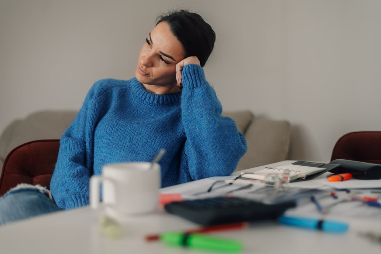 Stressed woman having tax problems trying to figure out finances at home