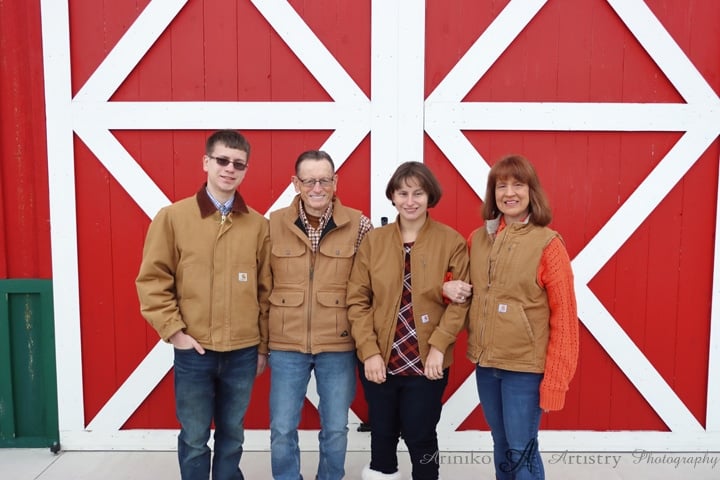 The Lothamer Family standing in front of the red barn at Red Cedar Preserve in Williamston, Michigan, start and finish of The Barn Run 5K